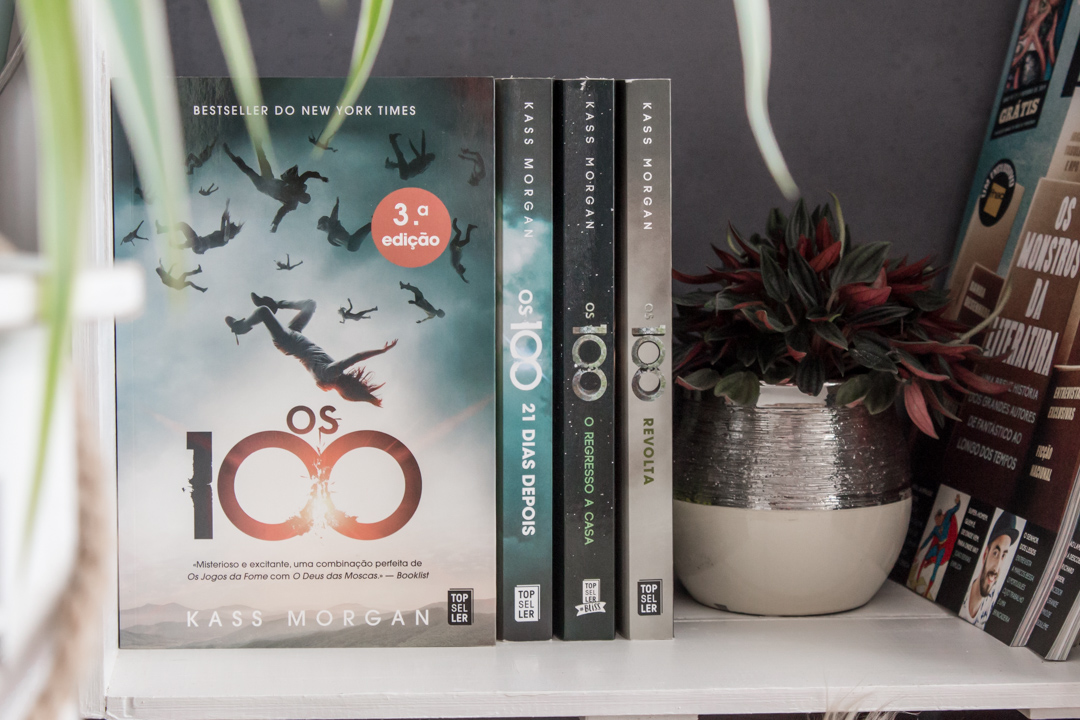 The 100 book cover facing forward with the next three books spines to its right.