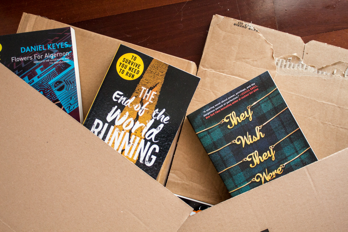 Flatlay of books coming out of cardboard boxes.