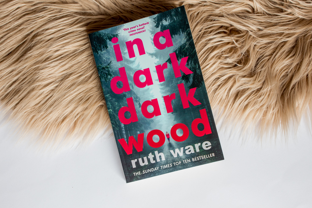 The book laied on top of a light brown fur against a white background.
