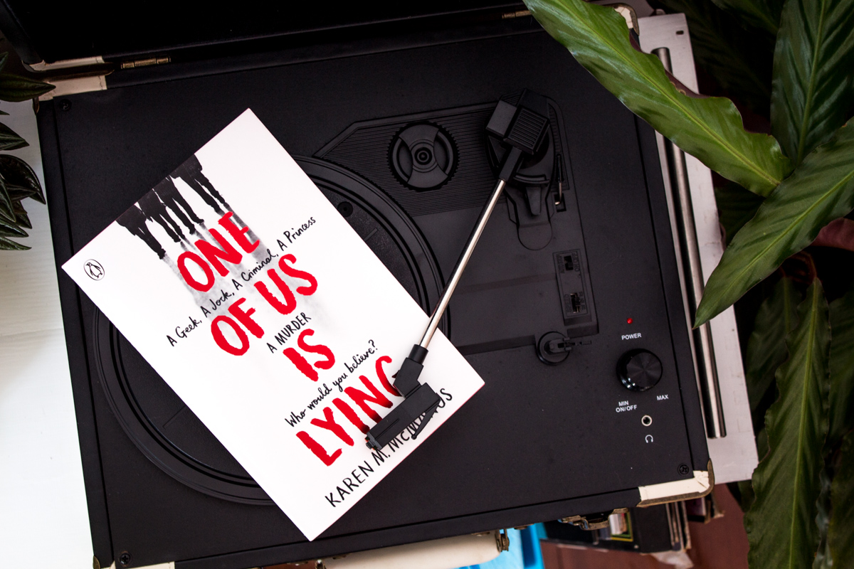 Book One of Us is Lying laying on a record player.
