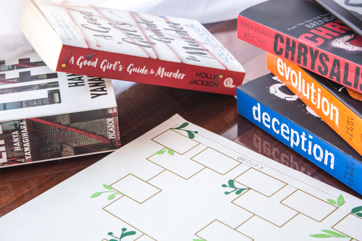 Pile of books next to an hand drawn tournament bracket.