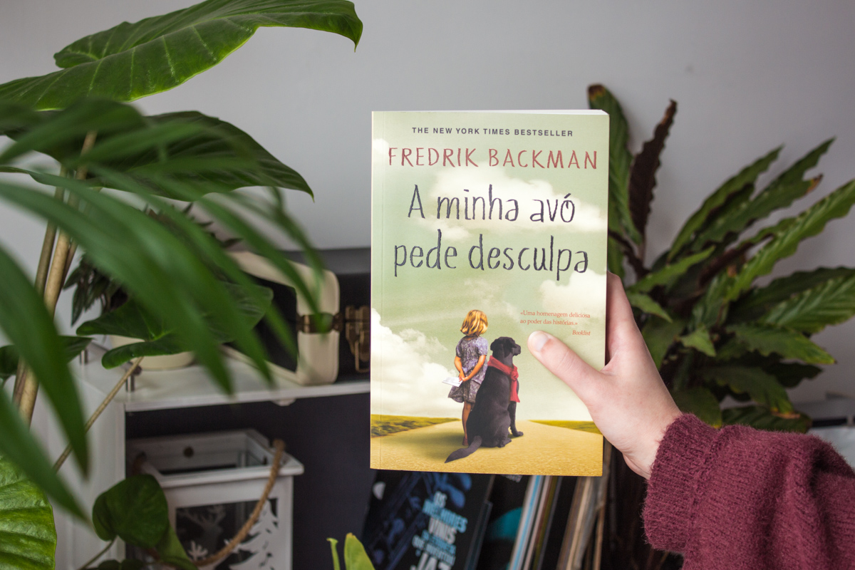 Holding the book My Grandmother Asked me to Tell You She's Sorry showing the cover.