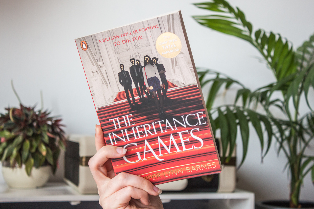 Holding the book up.