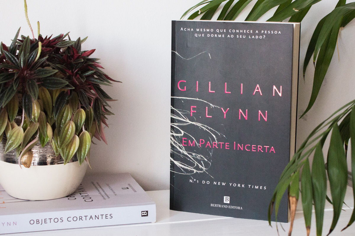 Book Gone Girl by Gillian Flynn on a table next to another book of the author.