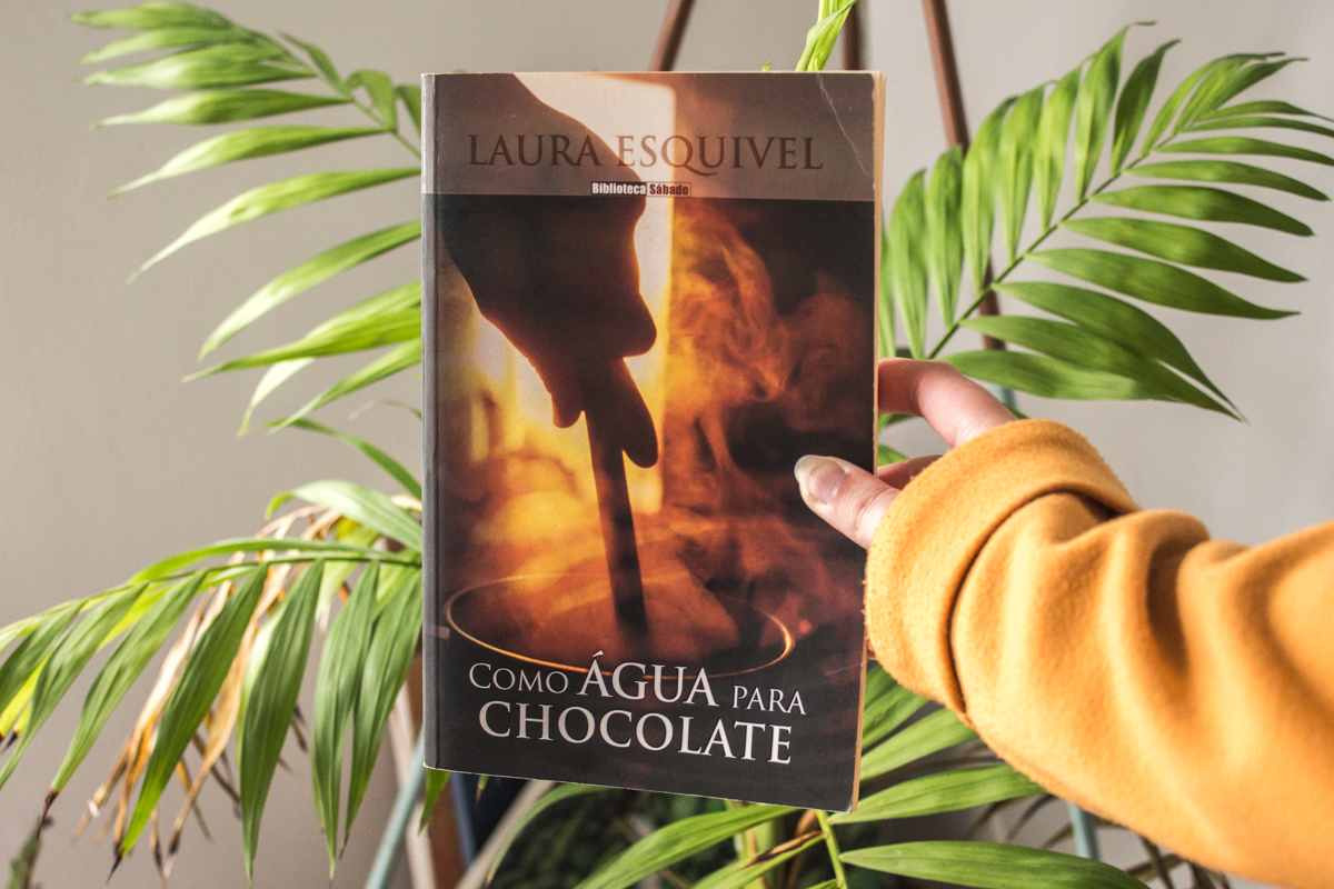 Holding the Portuguese edition of Like Water for Chocolate with one hand.