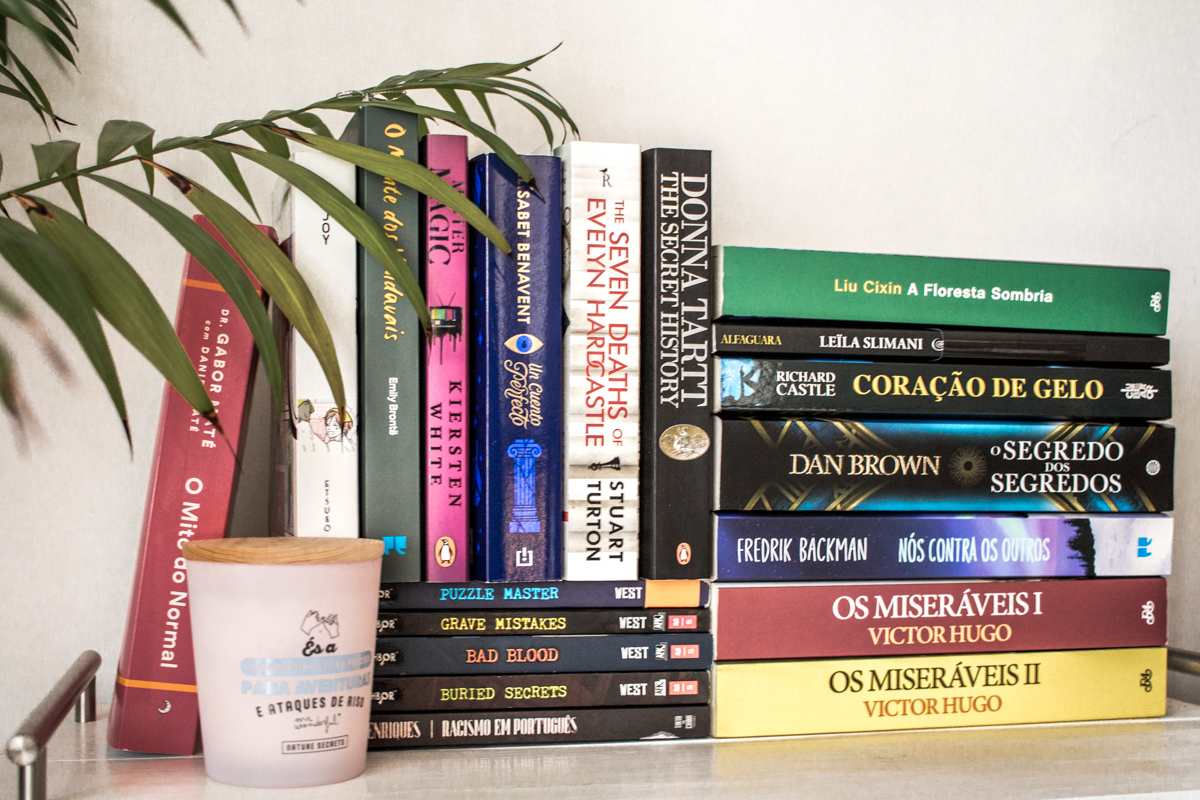 Books piled on top of each other on a table.