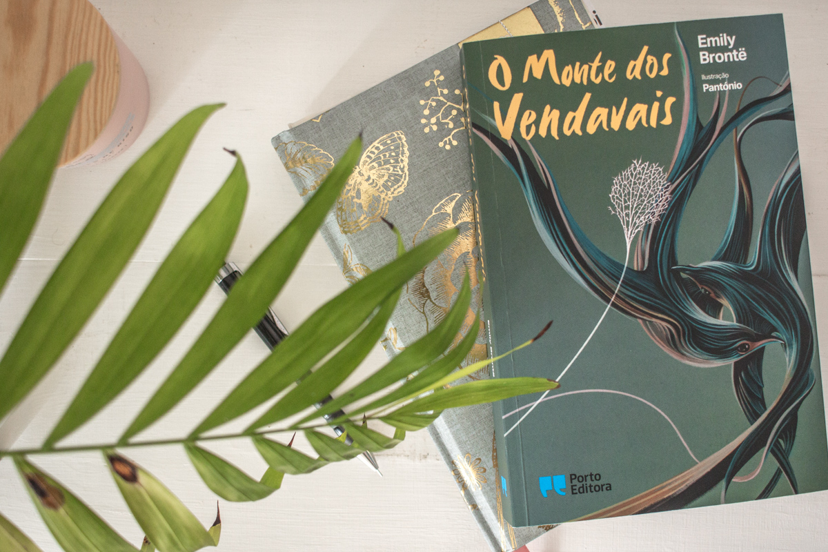 Book lay on top a journal on a table.