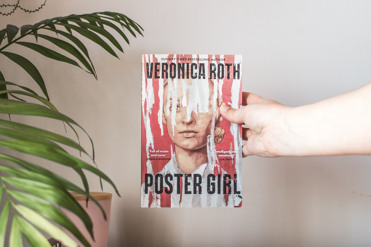 One hand holding the book up.