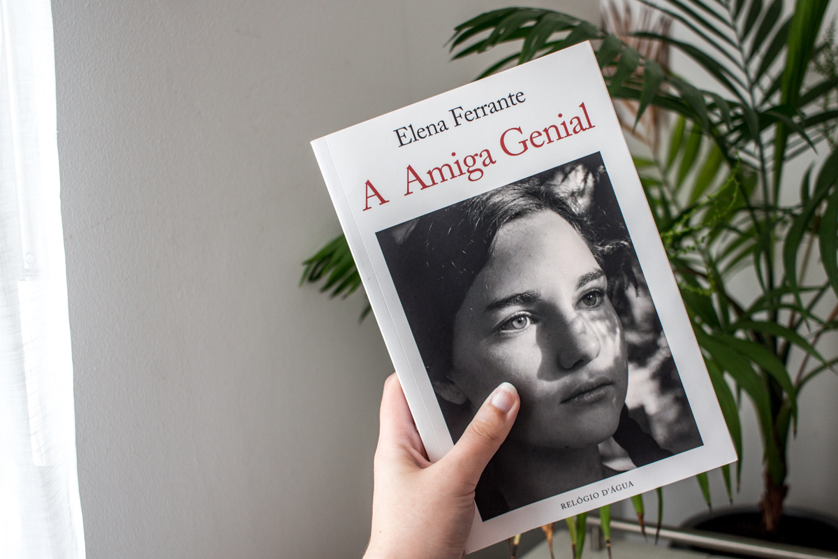 A hand holding the Portuguese edition of My Brilliant Friend.