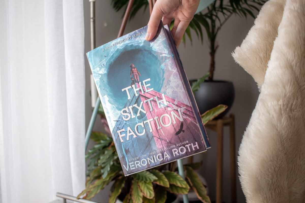 Holding the hardcover book by it's corner.